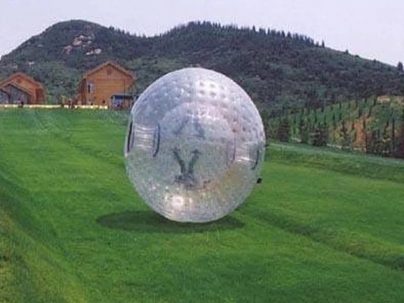 Large inflatable Zorb ball for rolling fun on grass or slopes. Perfect for outdoor events and activities. Buy online in Canada today!