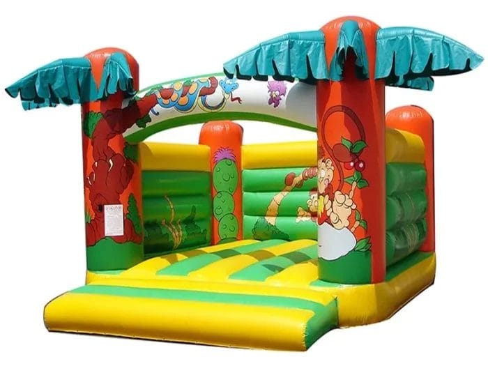 Tropical-themed bouncy castle with palm trees and jungle animal graphics, perfect for outdoor kids' parties. Buy online in Canada for fun and adventure!